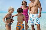 Children holding hands at the beach