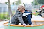 Toddler boys playing on playground