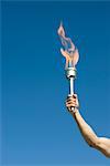 Man's arm holding up torch