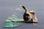 Female gymnast performing floor routine with ribbon