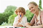 Mother and son coloring together, portrait