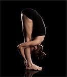 Studio shot of woman practicing yoga