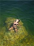 USA, Utah, Young woman relaxing in Lake Powell