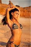 USA, Utah, Lake Powell, Young woman wearing bikini and looking away