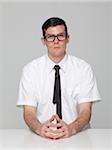 Studio portrait of young man wearing glasses and tie