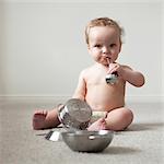 USA, Utah, Orem, Shirtless baby (6-11 months) playing with cooking utensils