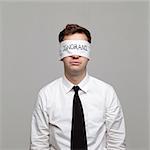 Studio portrait of young man with blindfold