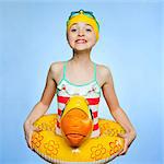 Studio portrait of girl (10-11) with inflatable ring