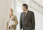 Executives walking through corridor of office building