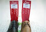 Shoes holding tag with sale price and sizes