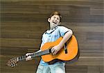 Boy playing guitar and singing