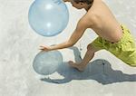 Boy catching ball on beach