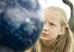 Girl looking at globe