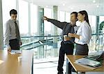 Business colleagues standing with cups of coffee, chatting