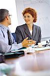 Business executives talking at conference table