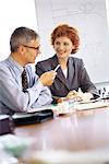 Business executives talking at conference table