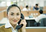 Businesswoman using phone in office