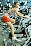 Woman riding exercise bike