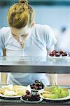 Young woman standing, choosing healthy snack in cafeteria