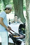 Man grilling meat on barbecue