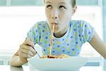 Girl slurping spaghetti noodles