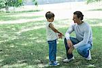Boy and father talking outdoors