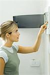 Woman pushing lever in fuse box