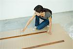 Woman staining slats of wood