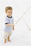 Young boy pretending to sword fight with stick