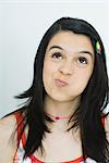 Teenage girl looking up with puffed cheeks, portrait