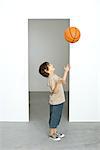 Boy throwing basketball into air