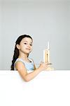 Little girl with small easel, smiling at camera