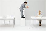 Businessman shouting with megaphone at employee, woman surrounded by crumpled paper balls