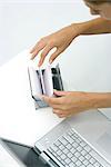 Woman flipping through card file, high angle view