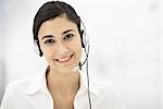 Professional woman wearing headset, smiling, portrait