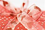 Gift wrapped with heart ribbon, extreme close-up