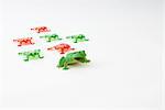 Toy frog leading group of smaller plastic frogs