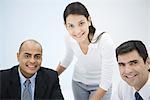 Business associates smiling at camera, portrait