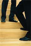 Businessmen standing on steps, low-section