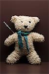 Syringe sticking out of teddy bear