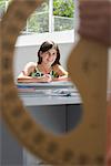 Female high school student in class, protractor in foreground