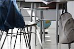 School desk and chair, globe sitting on floor in background