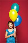 Girl holding balloons, portrait