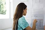 Female college student checking bulletin board