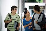 Male and female students walking and chatting together