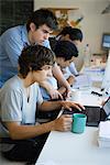 Male college students working together using laptop computer