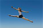 Young woman leaping, midair