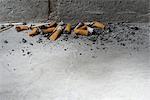 Discarded cigarette butts on ground