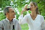 Mature couple together outdoors enjoying glass of wine