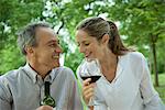 Mature couple enjoying red wine outdoors